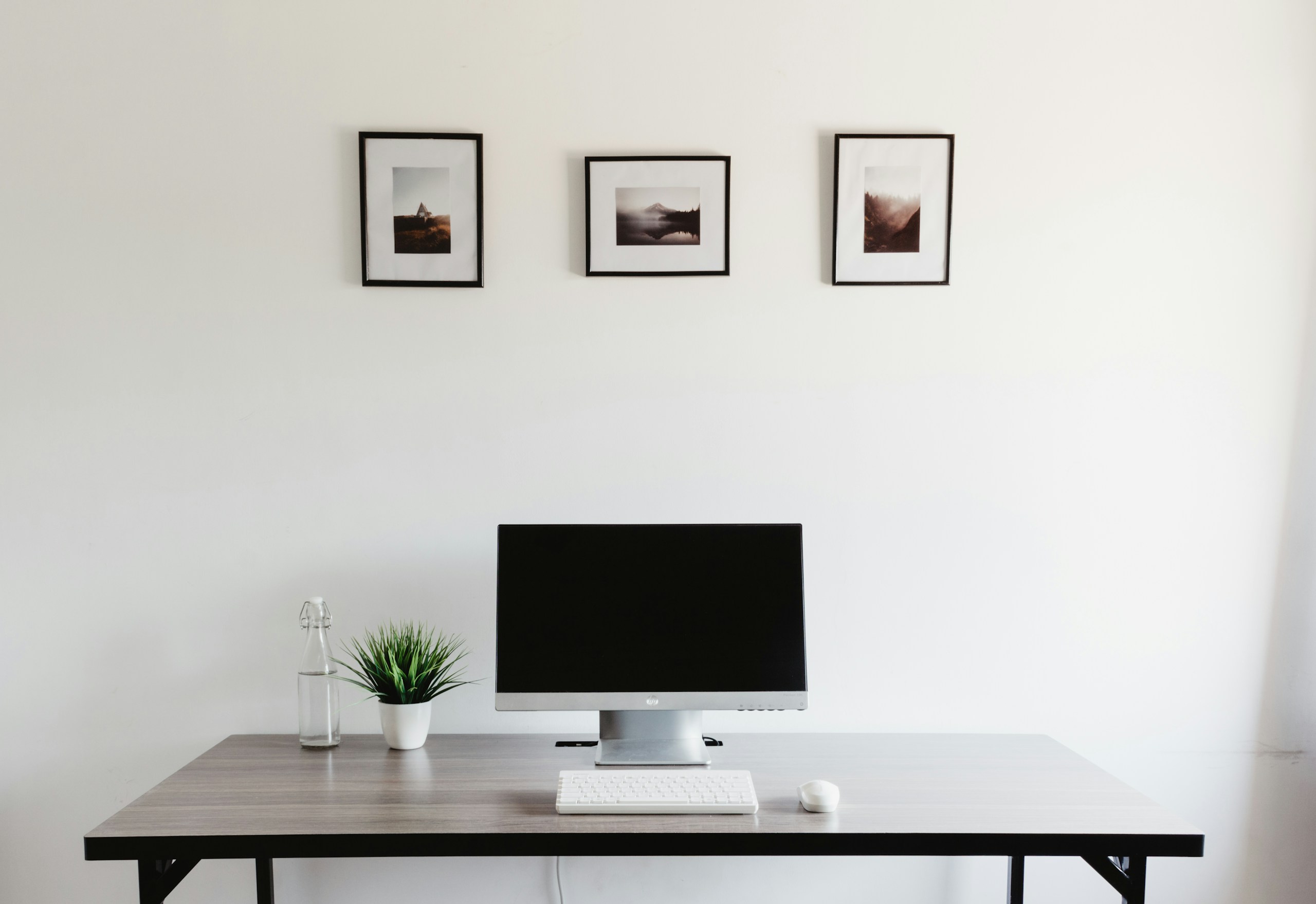 monitor, keyboard, and mouse on a clean desk workspace