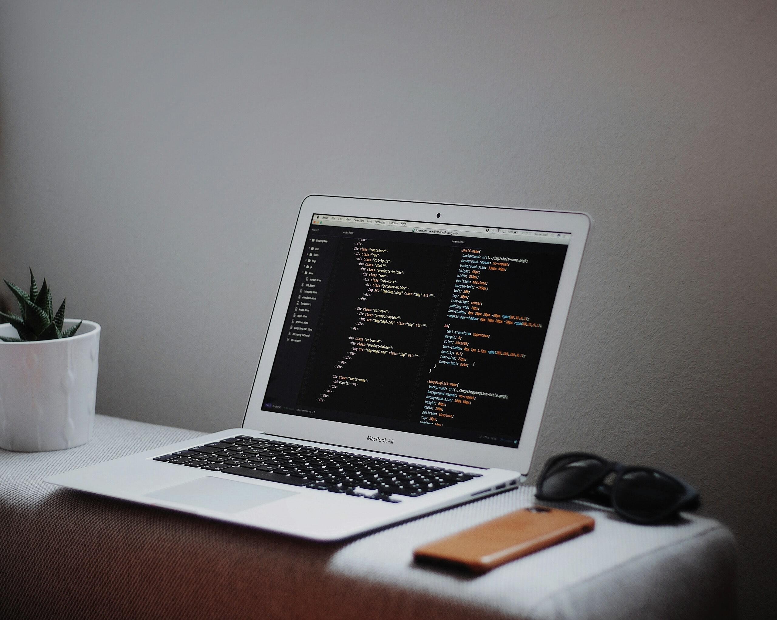 MacBook Air turned on and open on a minimal workspace desk